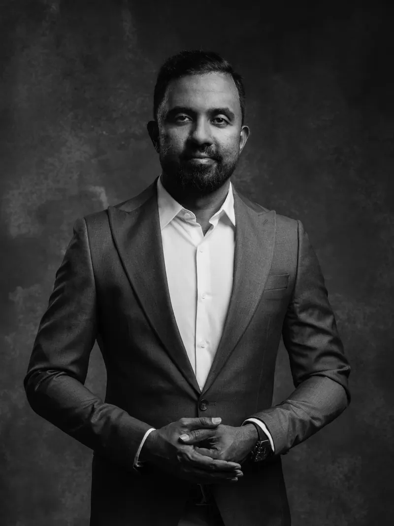 Don Sanjeewa Alwis standing with his hands clasped.