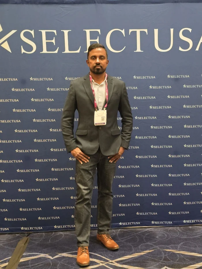 Portrait at the SelectUSA Investment Summit backdrop.